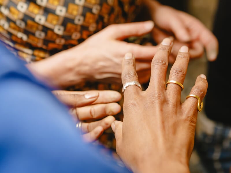 Woman's hand with three different handmade rings on it